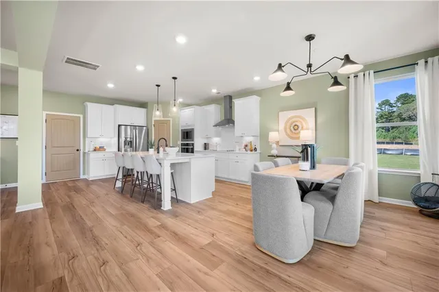 a living room with kitchen island furniture and a wooden floor