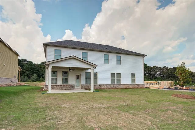 a front view of a house with a garden and plants