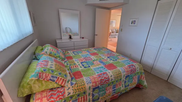 a bedroom with a bed and a small bathroom