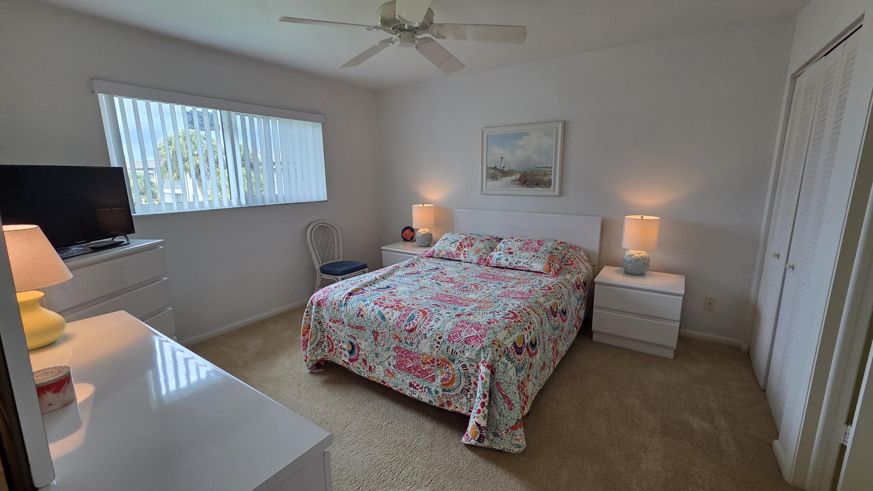 1014 Manatee Road, Unit F303 Naples, FL 34114 - Photo 17 of 22 a bedroom with a bed and a flat screen tv