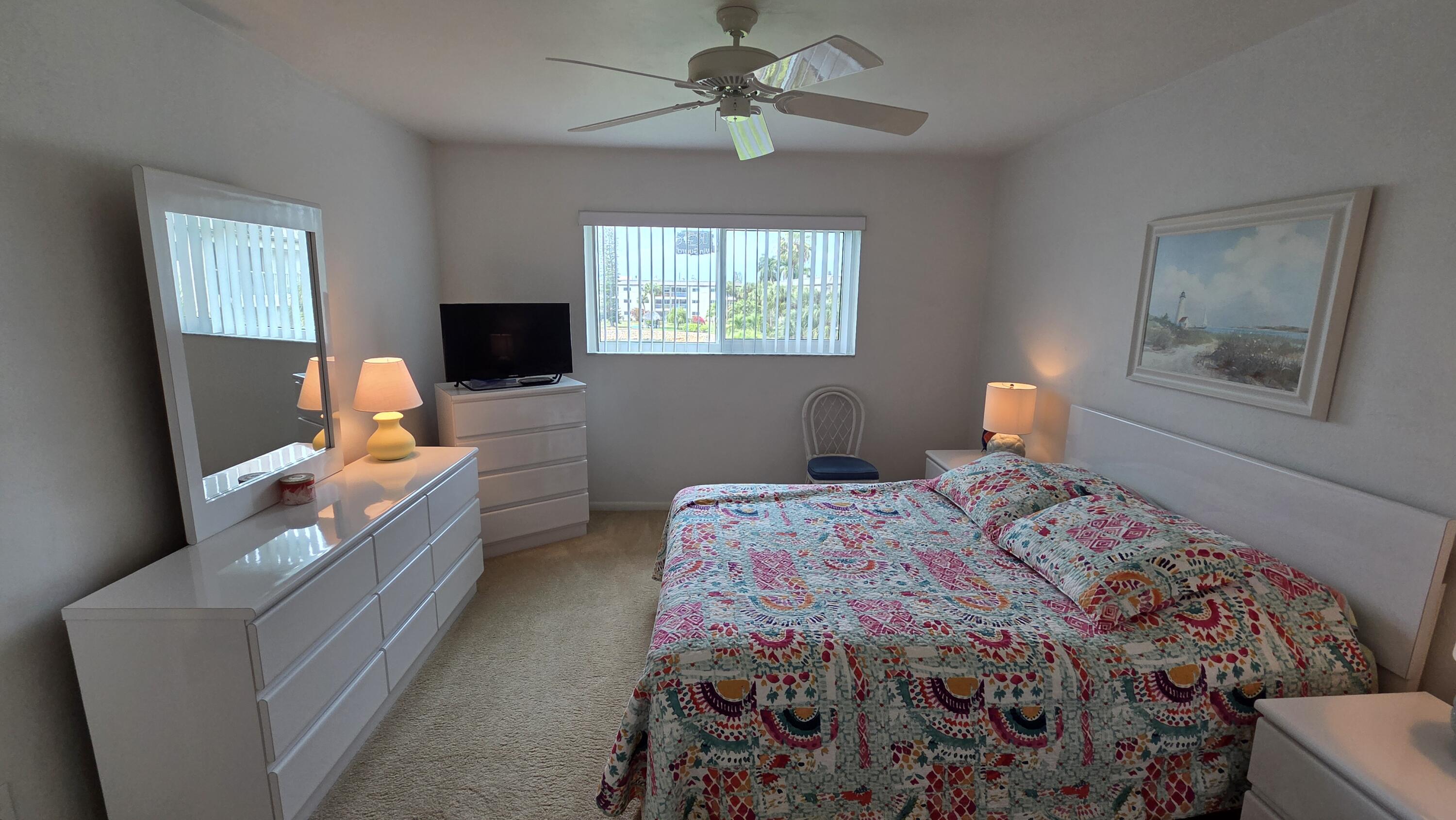 1014 Manatee Road, Unit F303 Naples, FL 34114 - Photo 18 of 22 a bedroom with a bed and a chandelier