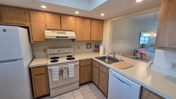 a kitchen with a sink a stove and cabinets