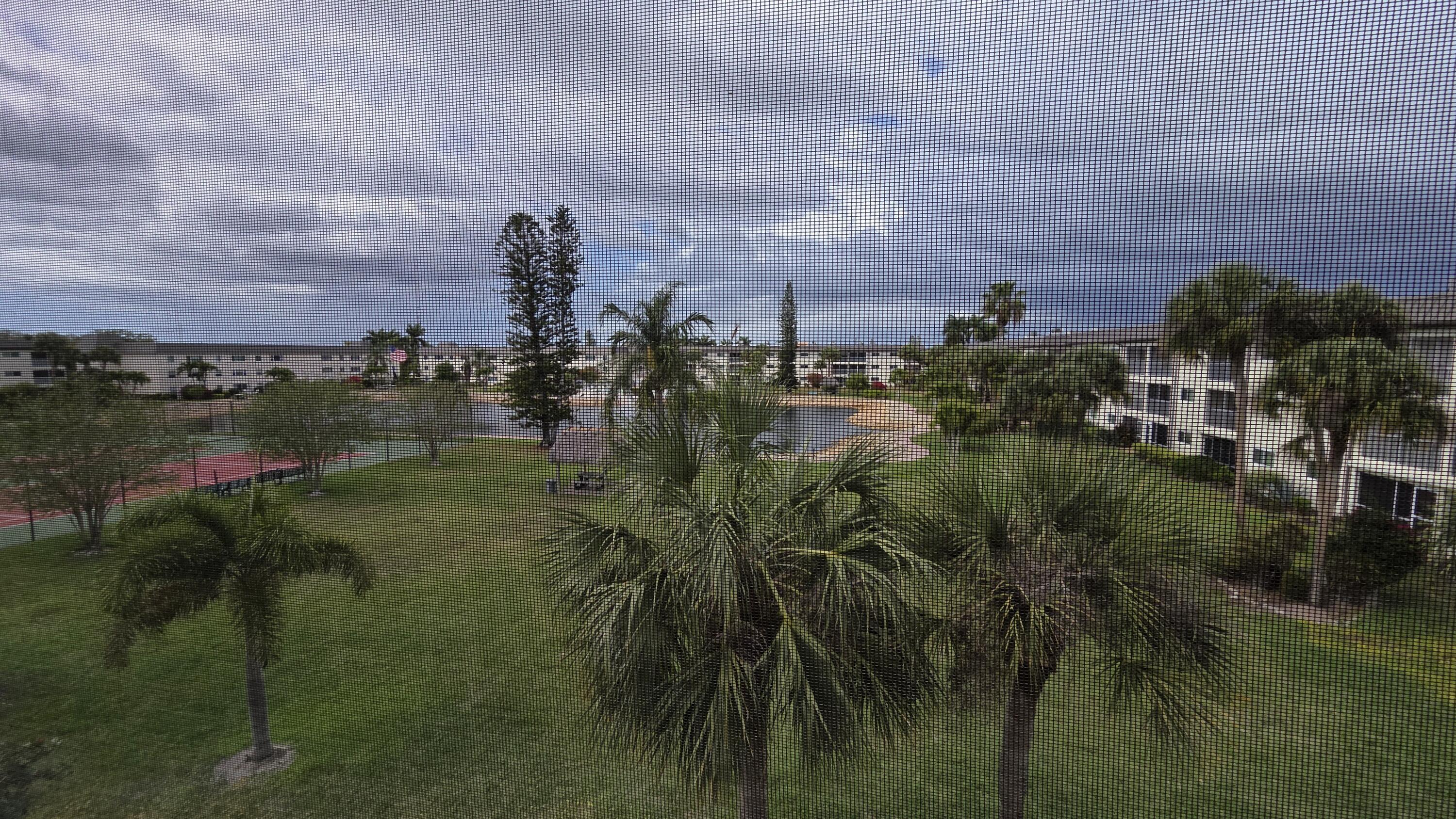 1014 Manatee Road, Unit F303 Naples, FL 34114 - Photo 21 of 22 a view of a lake with a building in the background