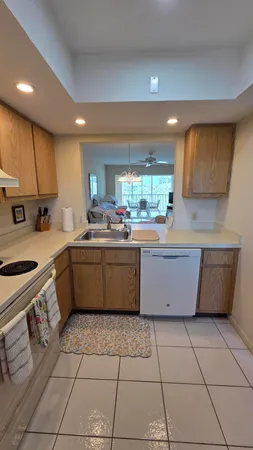 a kitchen with a sink a stove a microwave and cabinets