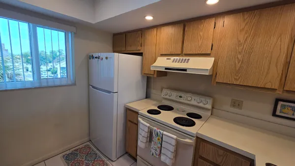 a kitchen with a refrigerator and a stove