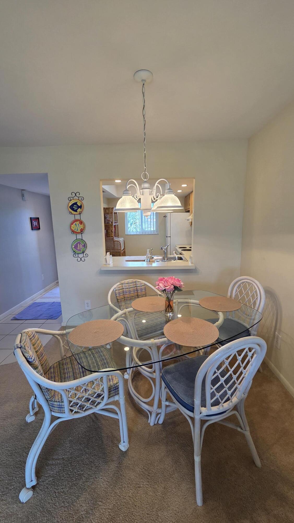 1014 Manatee Road, Unit F303 Naples, FL 34114 - Photo 6 of 22 a table and chairs in a room