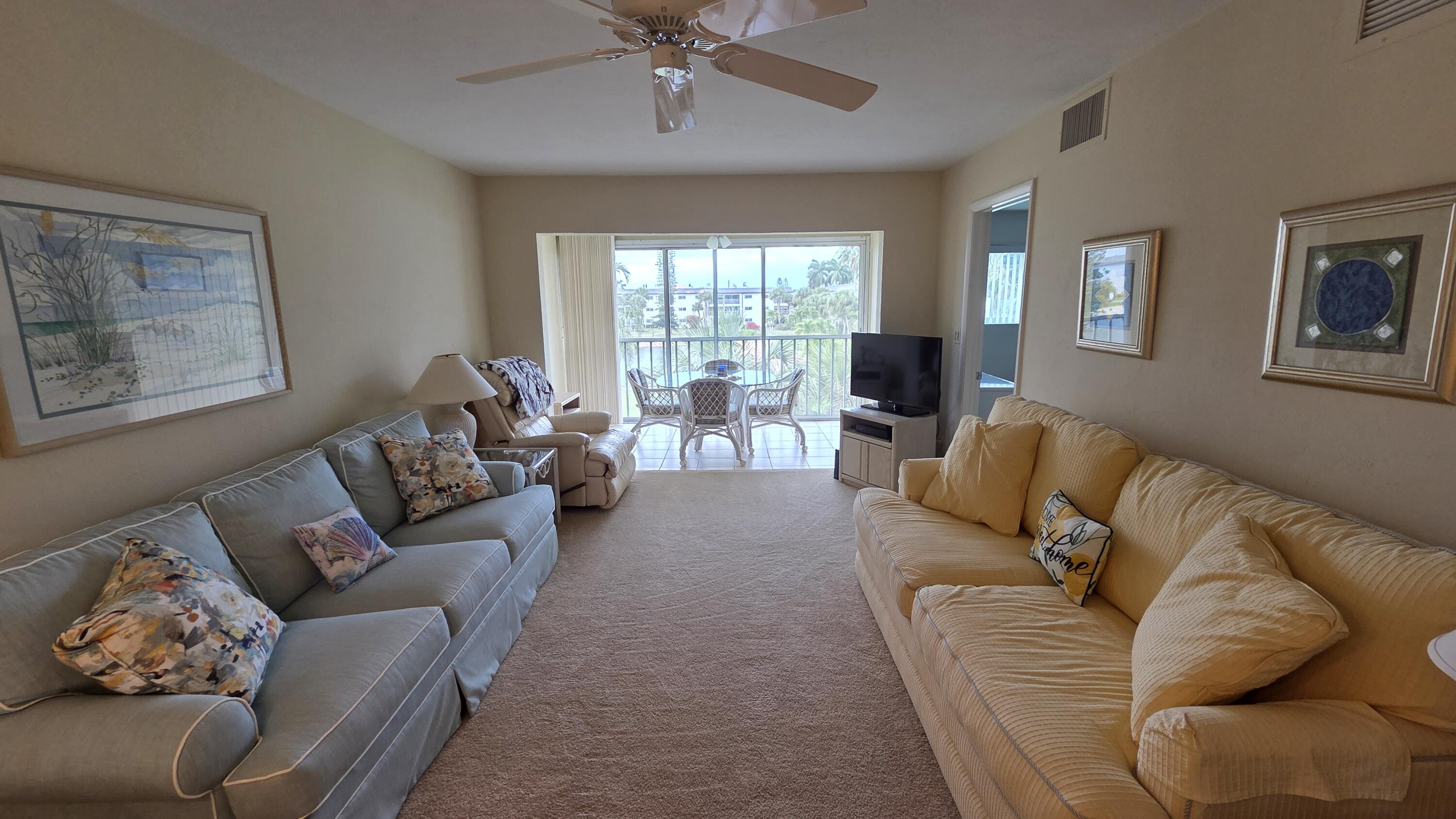 1014 Manatee Road, Unit F303 Naples, FL 34114 - Photo 8 of 22 a living room with furniture and a large window