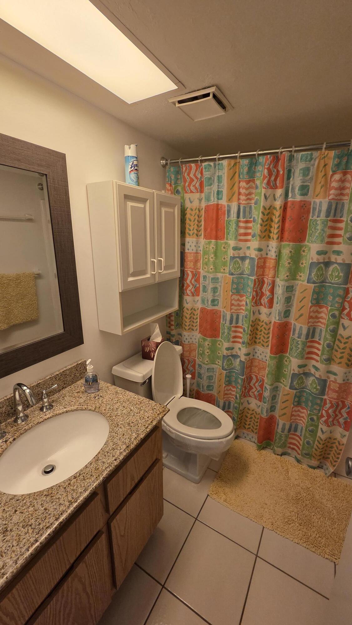 1014 Manatee Road, Unit F303 Naples, FL 34114 - Photo 9 of 22 a bathroom with a granite countertop sink and a mirror