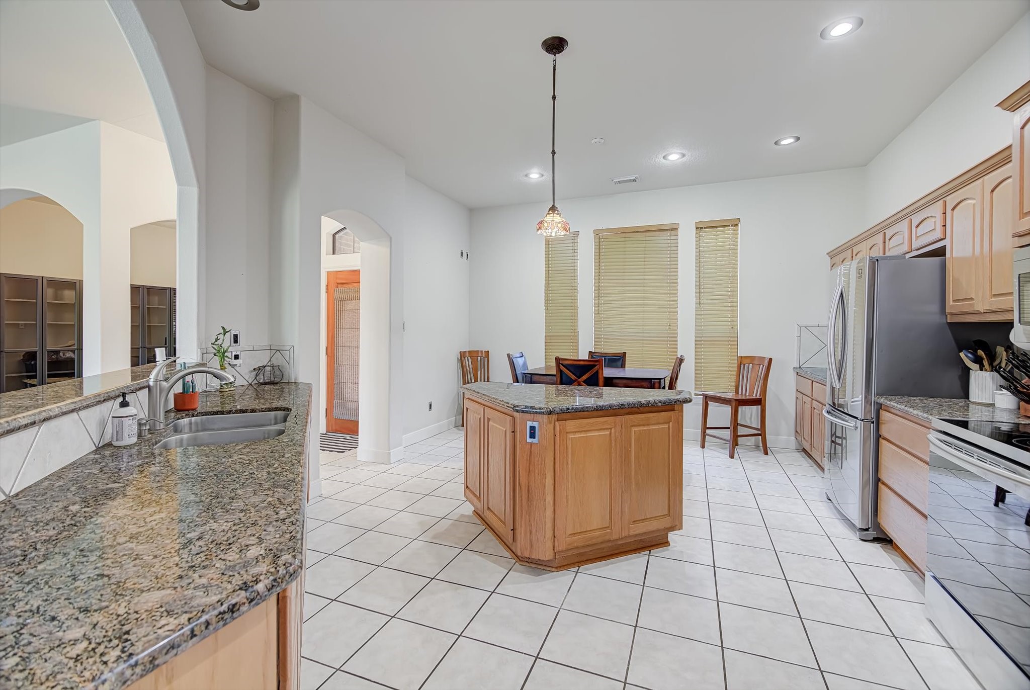 3850 Farm To Market 1010 Road Cleveland, TX 77327 - Photo 12 of 49 a large kitchen with kitchen island granite countertop a large counter top and stainless steel appliances