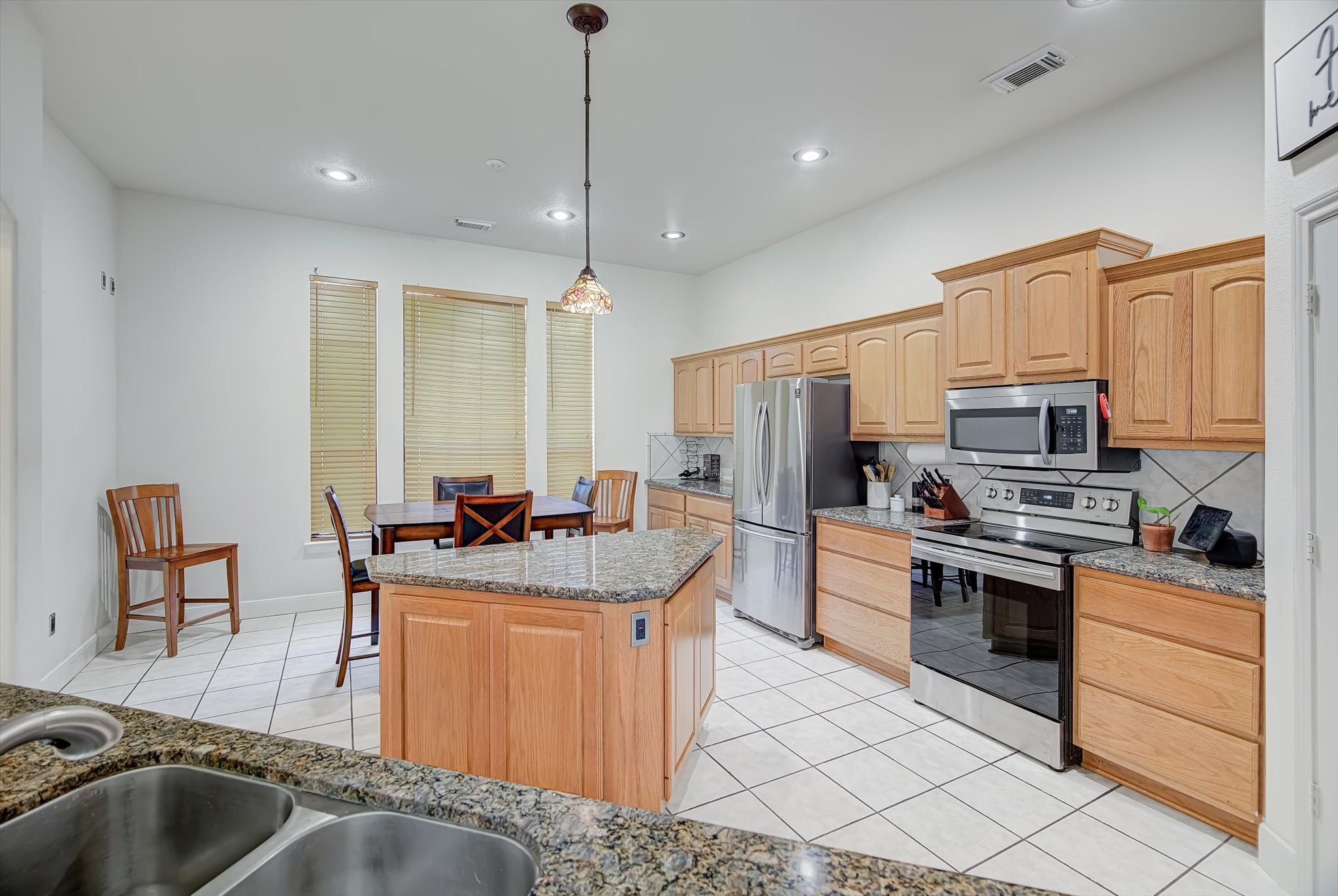 3850 Farm To Market 1010 Road Cleveland, TX 77327 - Photo 13 of 49 a kitchen with stainless steel appliances granite countertop a sink stove and refrigerator