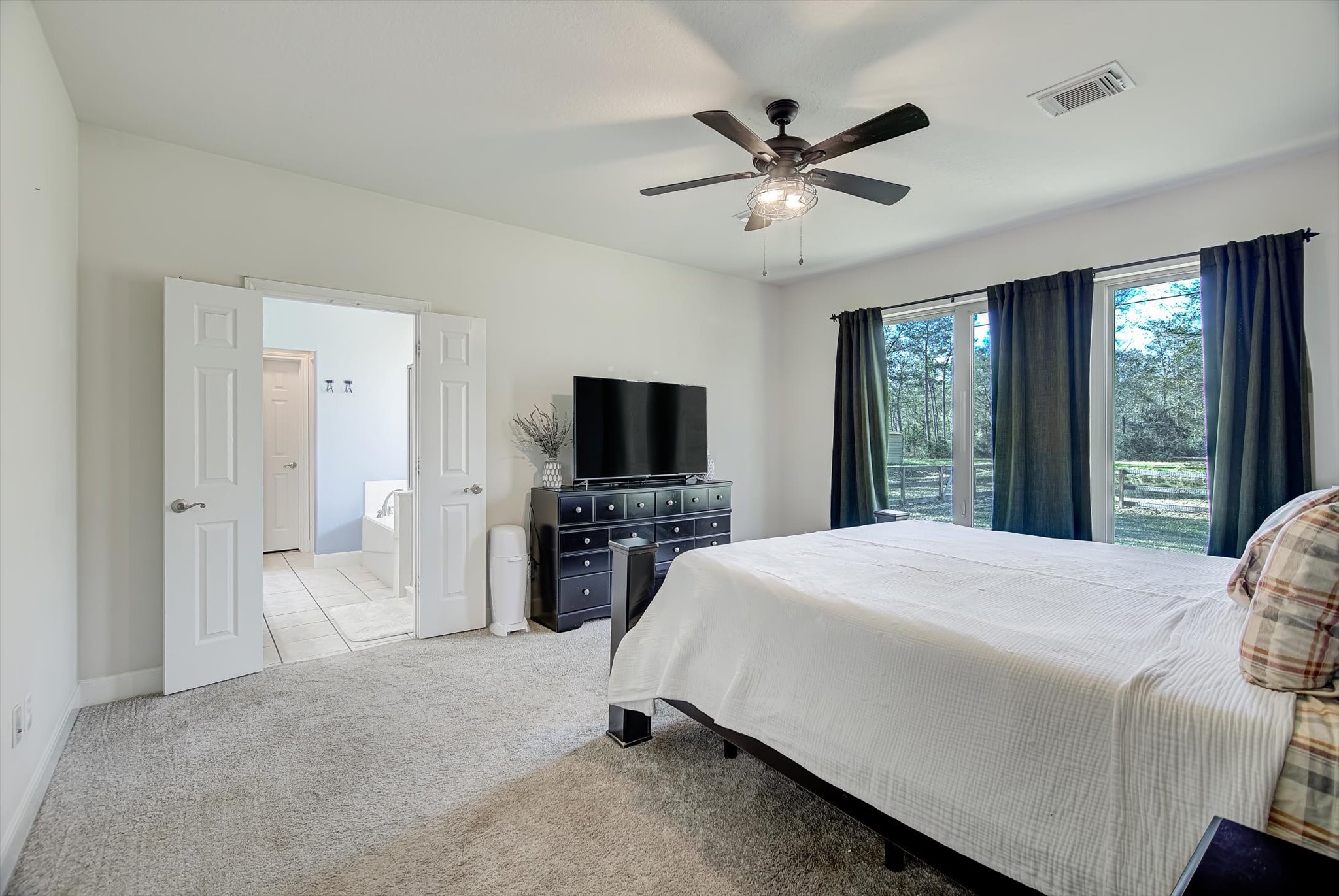 3850 Farm To Market 1010 Road Cleveland, TX 77327 - Photo 20 of 49 a bedroom with a bed and a flat screen tv