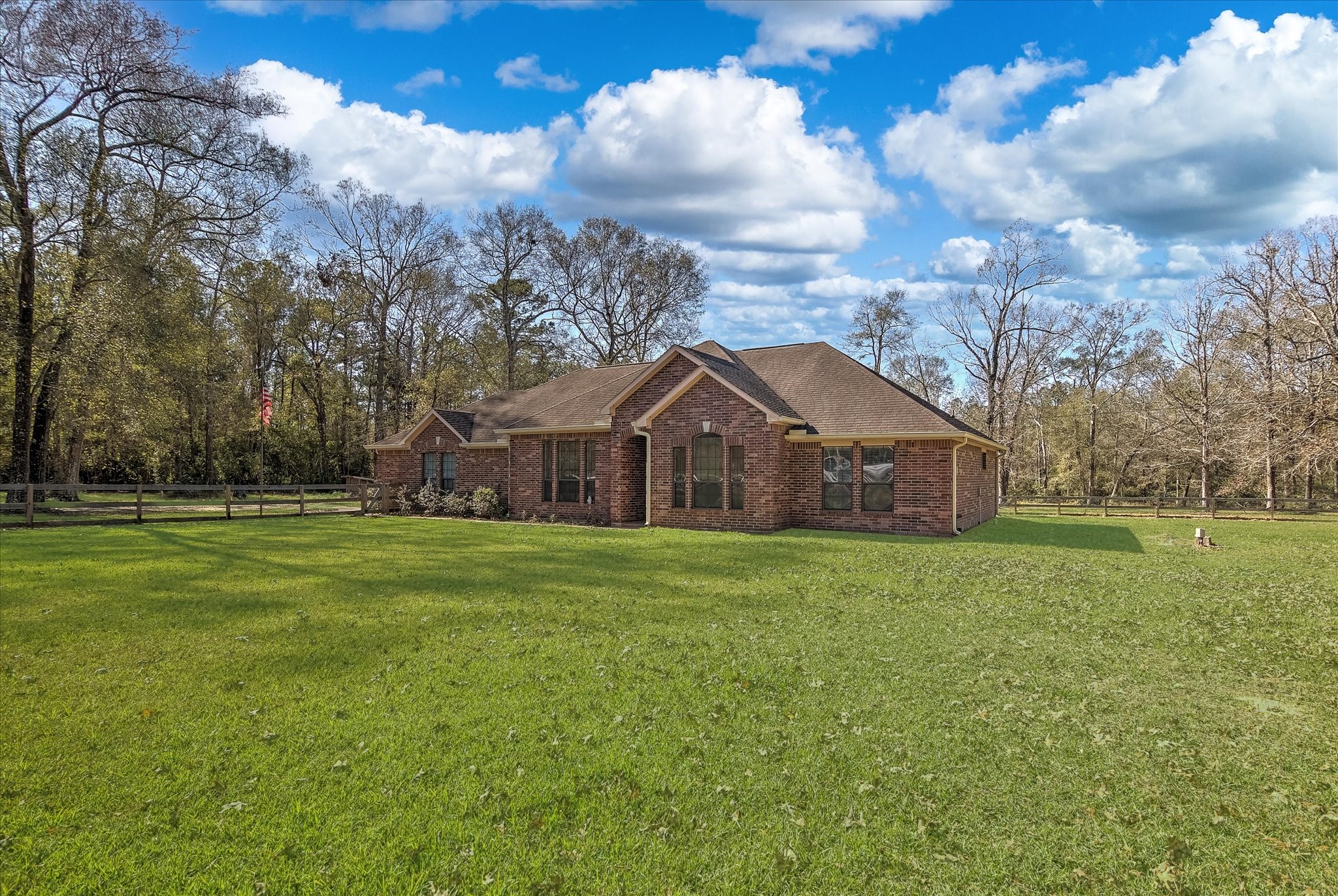3850 Farm To Market 1010 Road Cleveland, TX 77327 - Photo 4 of 49 a front view of a house with garden