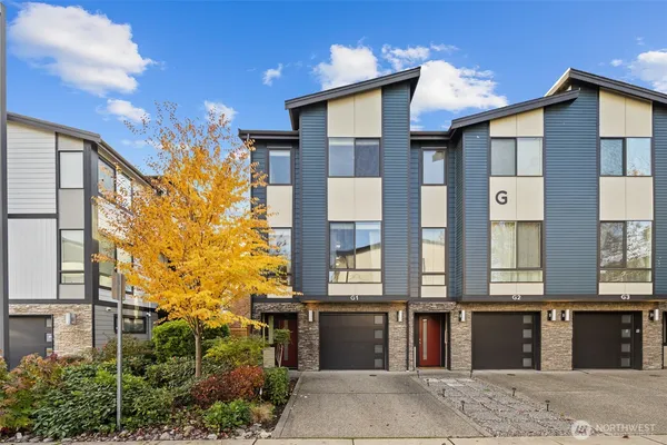 a front view of a residential apartment building with a yard