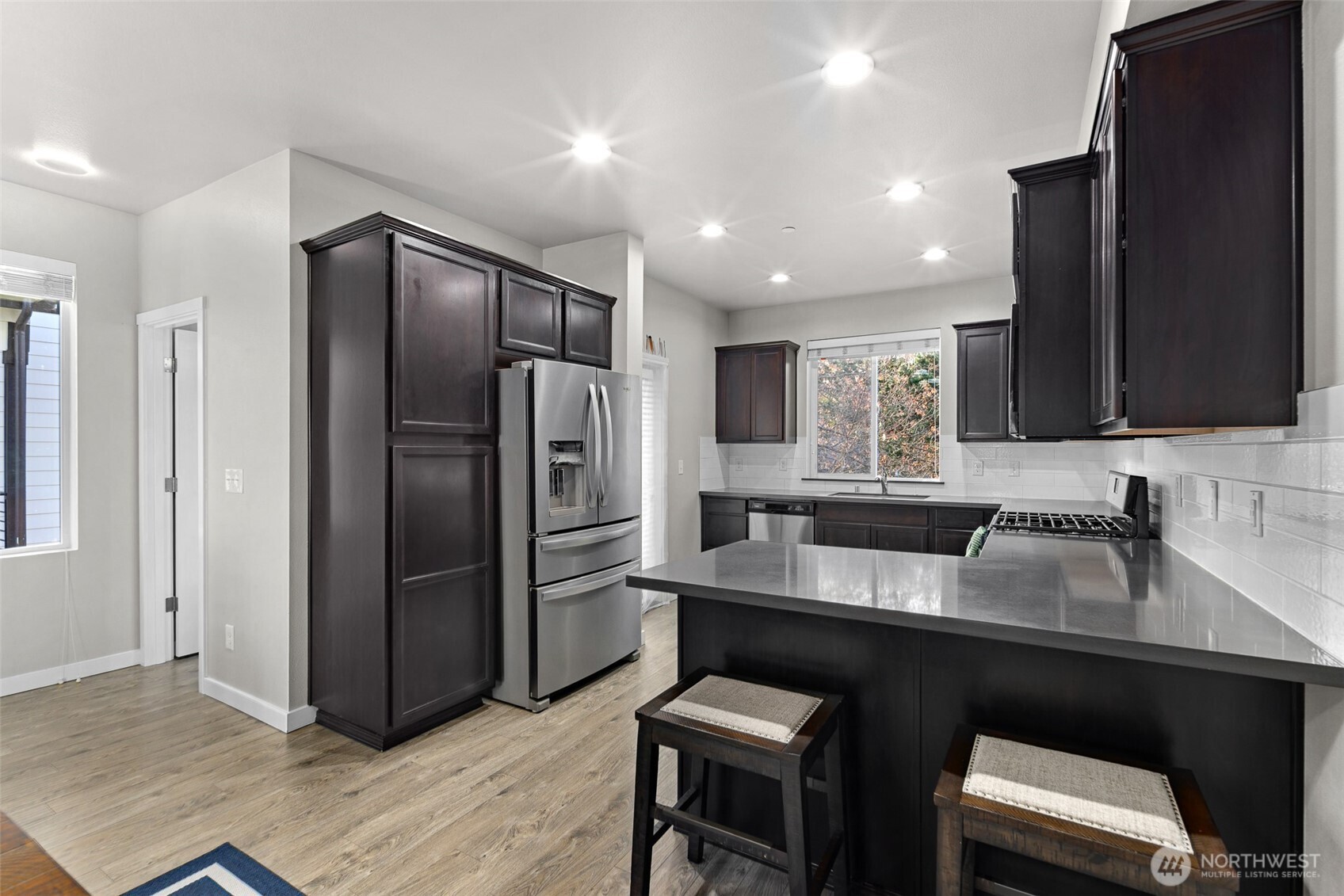 729 112th Street Southwest, Unit G1 Everett, WA 98204 - Photo 12 of 32 a kitchen with granite countertop a refrigerator and a sink