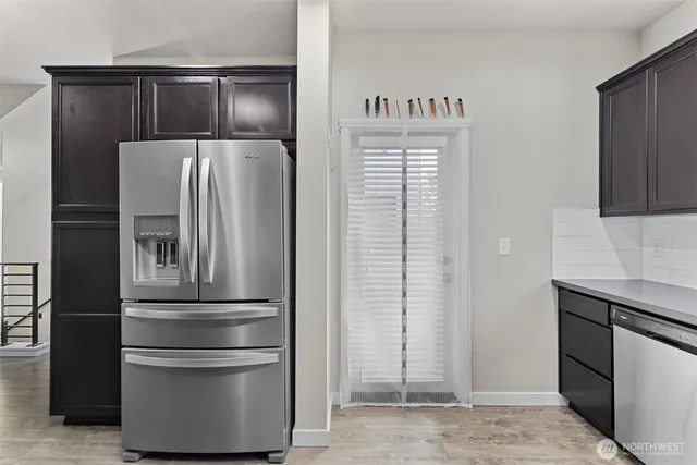 a kitchen with metallic refrigerator freezer and a dishwasher