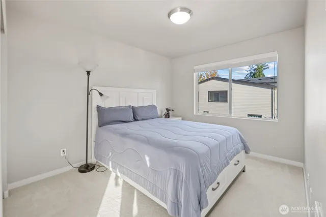 a bedroom with a bed and window