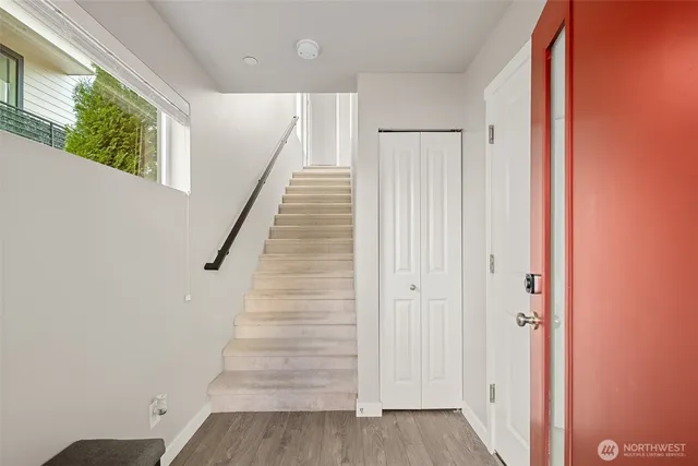 a view of entryway with wooden floor and stairs