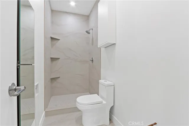 a bathroom with a toilet and shower