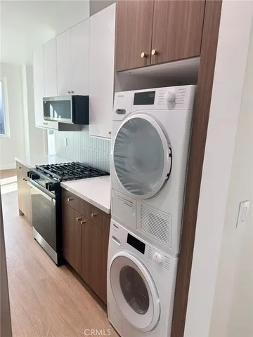 a kitchen with a stove top oven and sink