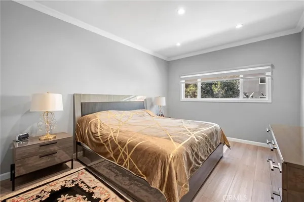 a bedroom with a bed and a wall painting