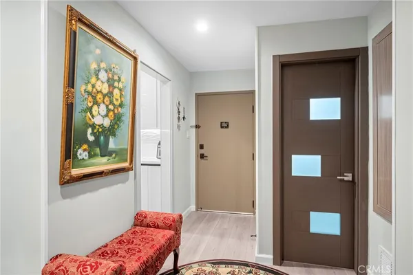 a living room with furniture and a view of kitchen
