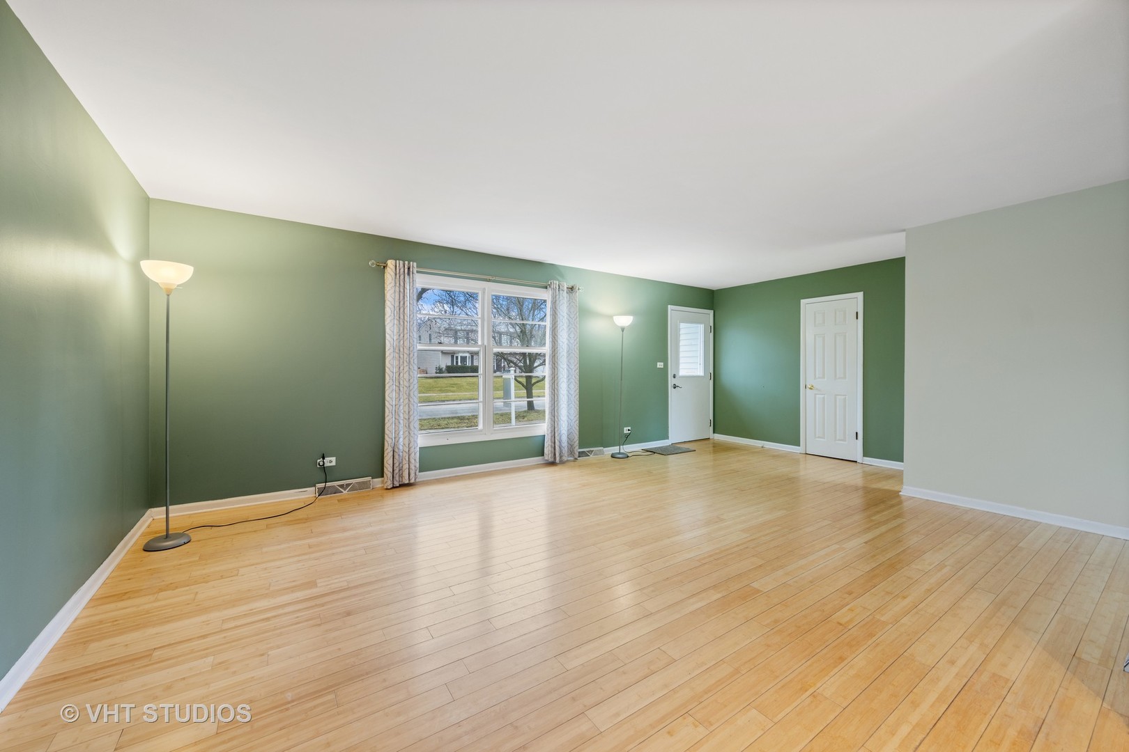 117 West Bailey Road Naperville, IL 60565 - Photo 5 of 22 a view of an empty room with wooden floor and a window