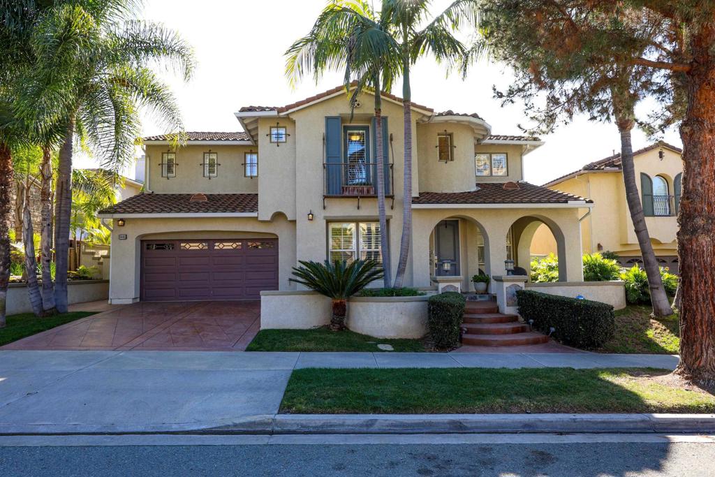 a front view of a house with garden and plants