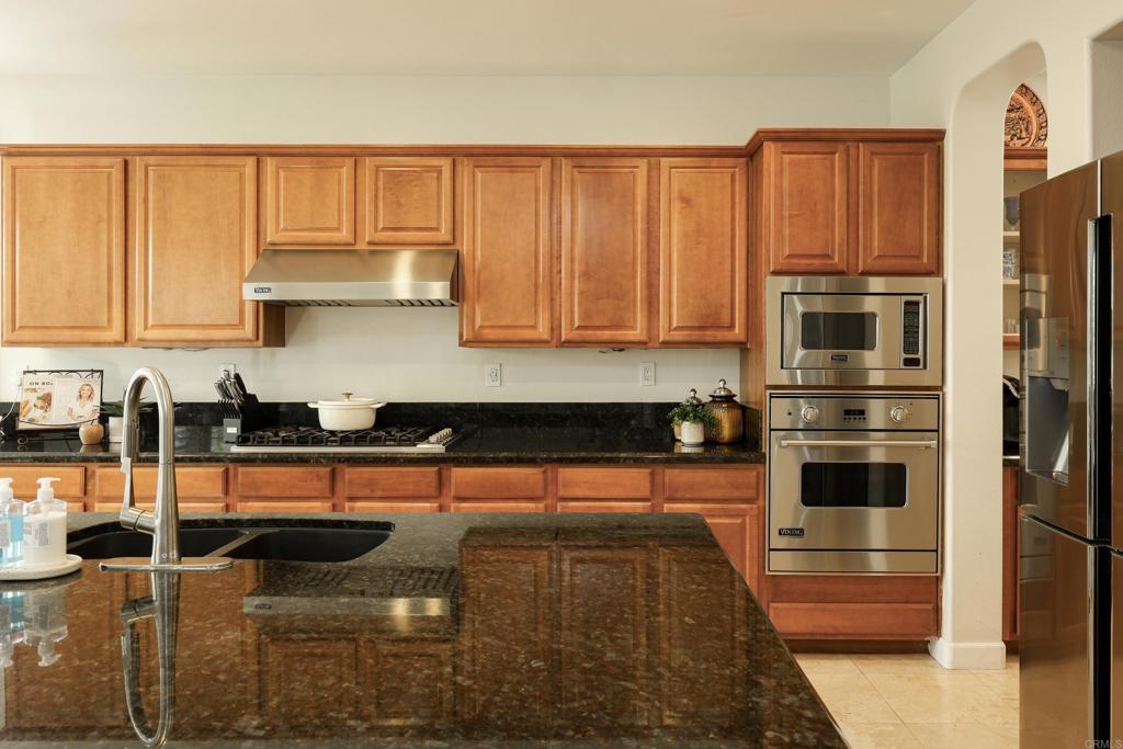 1446 Old Janal Ranch Road Chula Vista, CA 91915 - Photo 13 of 51 a kitchen with stainless steel appliances granite countertop a stove a sink and a refrigerator