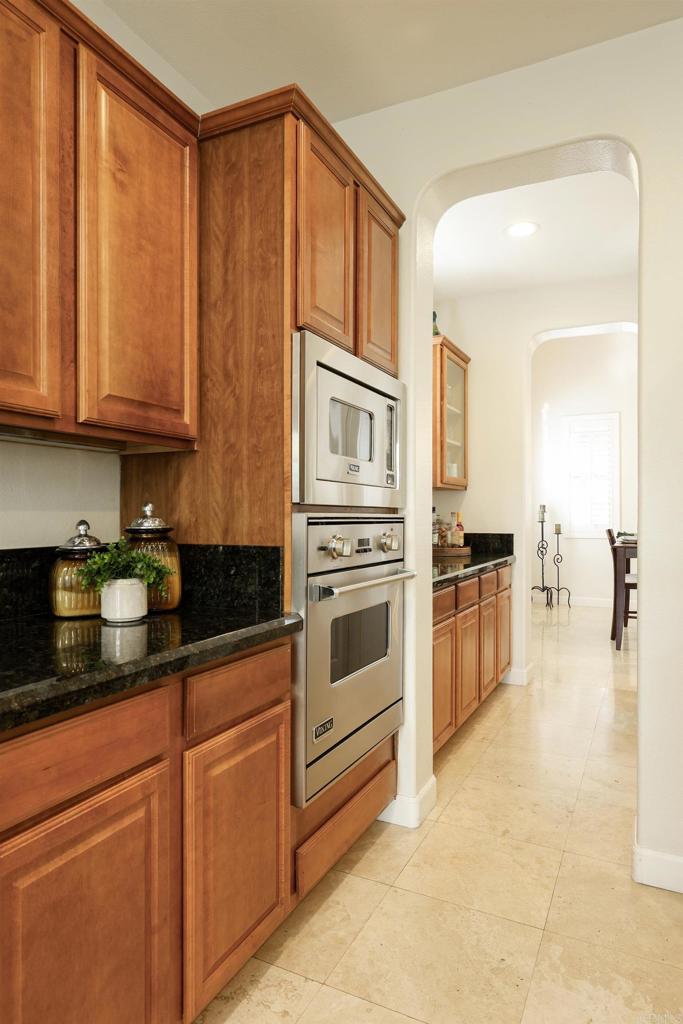 1446 Old Janal Ranch Road Chula Vista, CA 91915 - Photo 14 of 51 a kitchen with stainless steel appliances granite countertop a stove a sink and a microwave