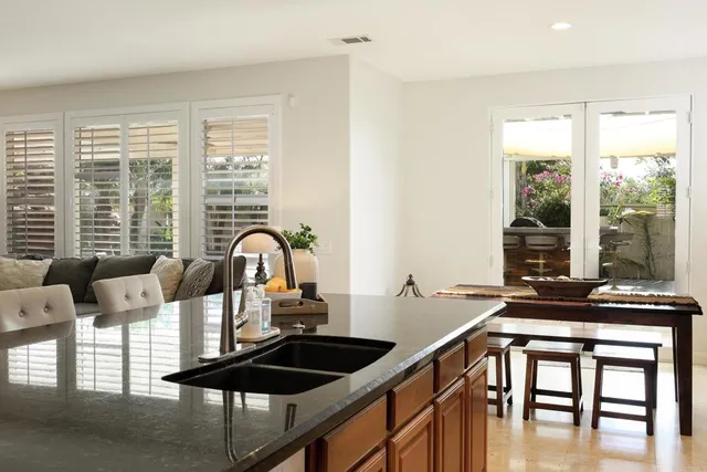 a living room with furniture and floor to ceiling windows