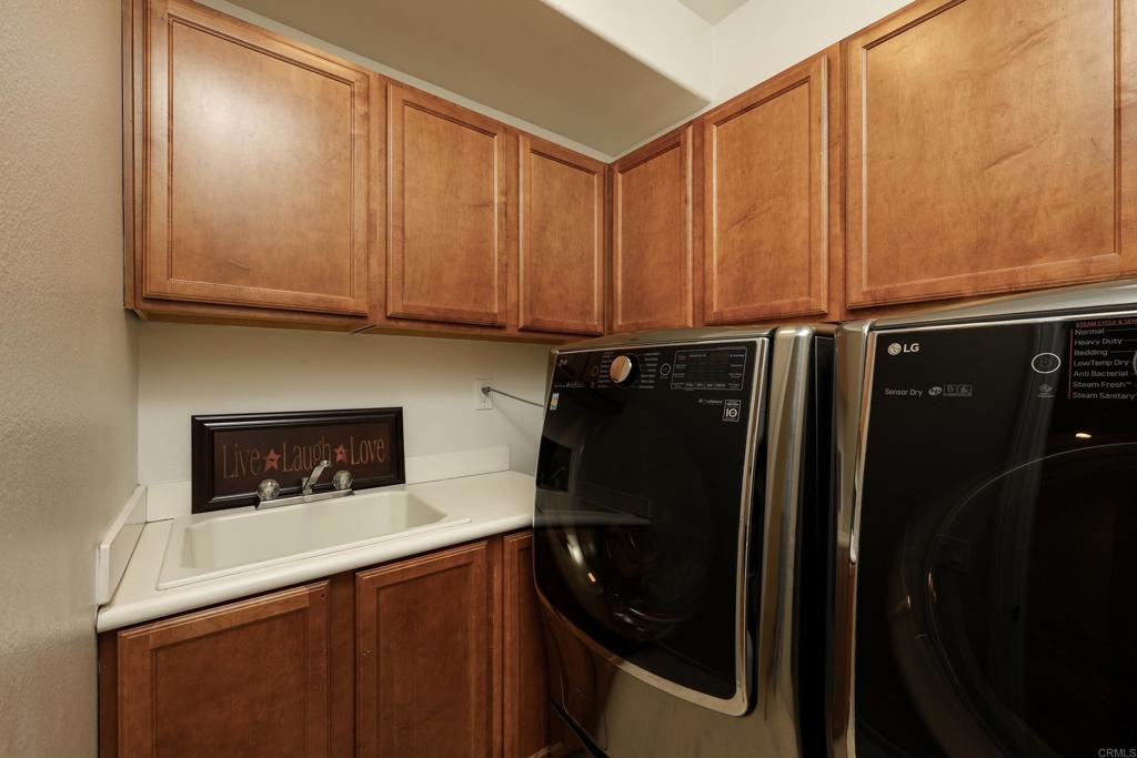1446 Old Janal Ranch Road Chula Vista, CA 91915 - Photo 19 of 51 a kitchen with a refrigerator and cabinets
