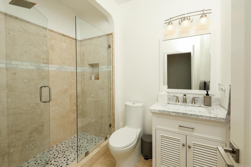 1446 Old Janal Ranch Road Chula Vista, CA 91915 - Photo 20 of 51 a bathroom with a granite countertop sink toilet and shower