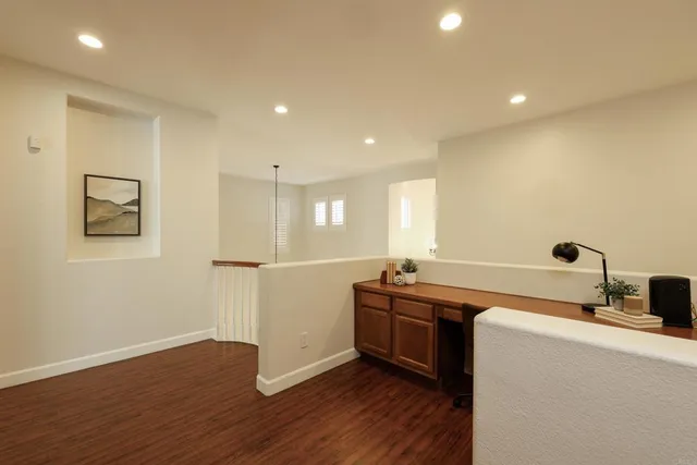 a spacious bedroom with a bed and wooden floor