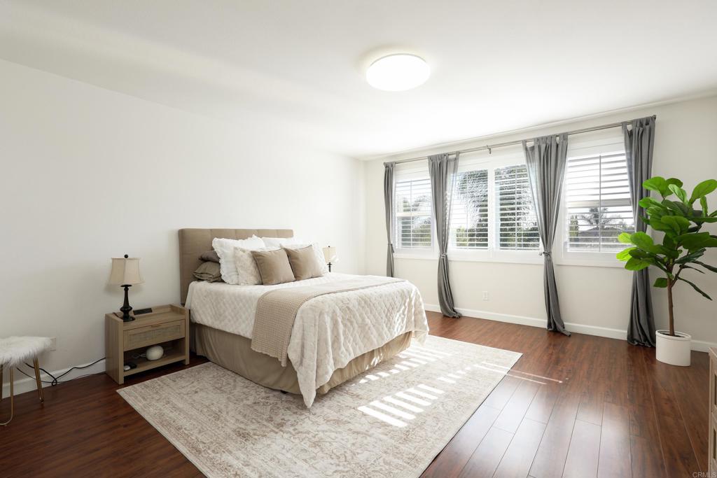 1446 Old Janal Ranch Road Chula Vista, CA 91915 - Photo 22 of 51 a spacious bedroom with a bed and wooden floor