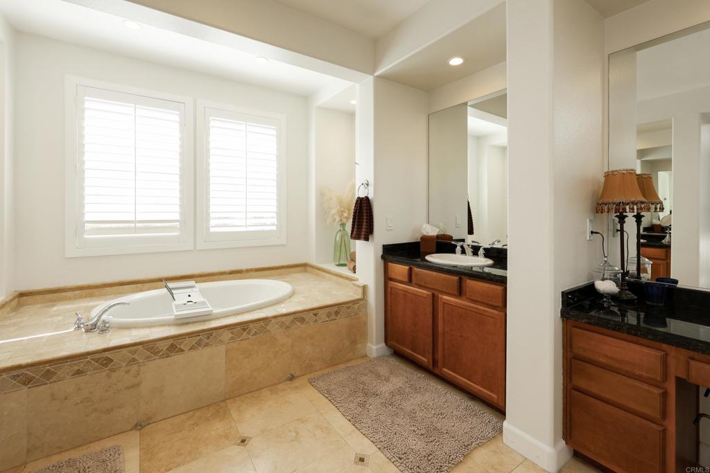 1446 Old Janal Ranch Road Chula Vista, CA 91915 - Photo 26 of 51 a spacious bathroom with a granite countertop tub sink and mirror
