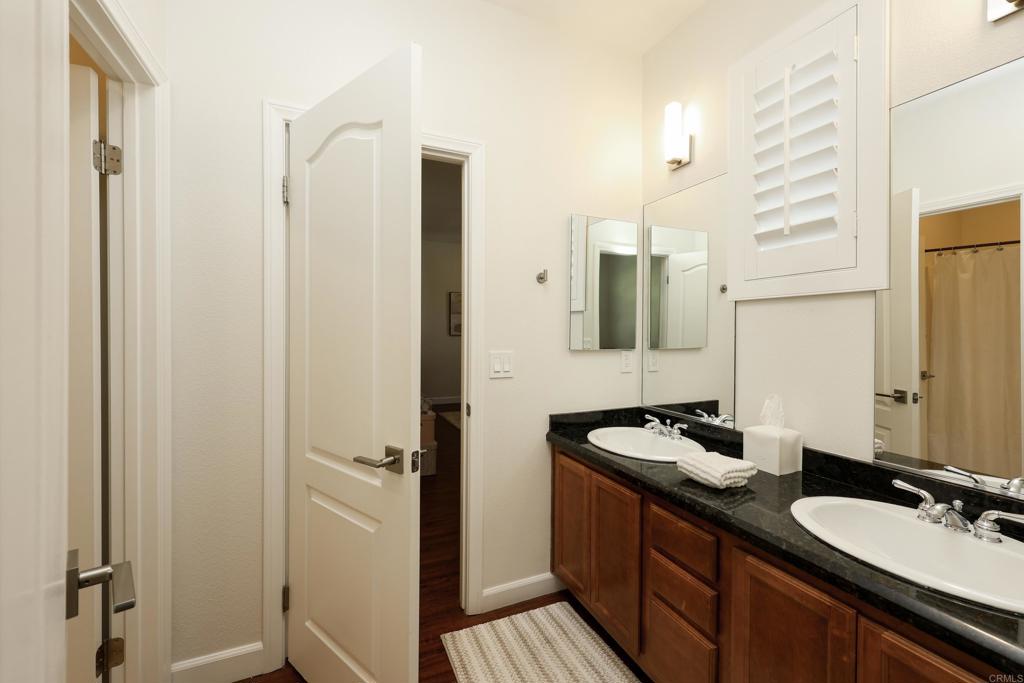 1446 Old Janal Ranch Road Chula Vista, CA 91915 - Photo 33 of 51 a bathroom with a double vanity sink and mirror