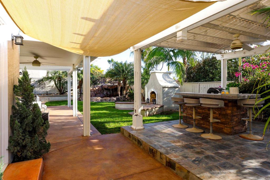 1446 Old Janal Ranch Road Chula Vista, CA 91915 - Photo 38 of 51 a view of a patio with table and chairs potted plants with floor to ceiling window and potted plants