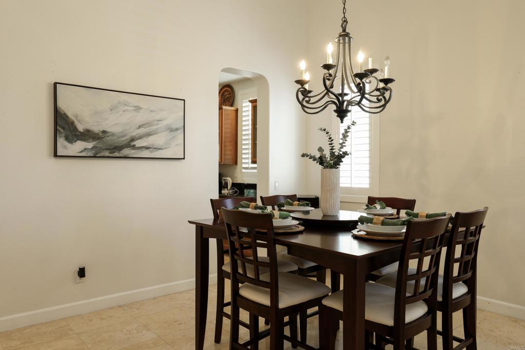 1446 Old Janal Ranch Road Chula Vista, CA 91915 - Photo 4 of 51 a view of a dining room with furniture wooden floor and chandelier