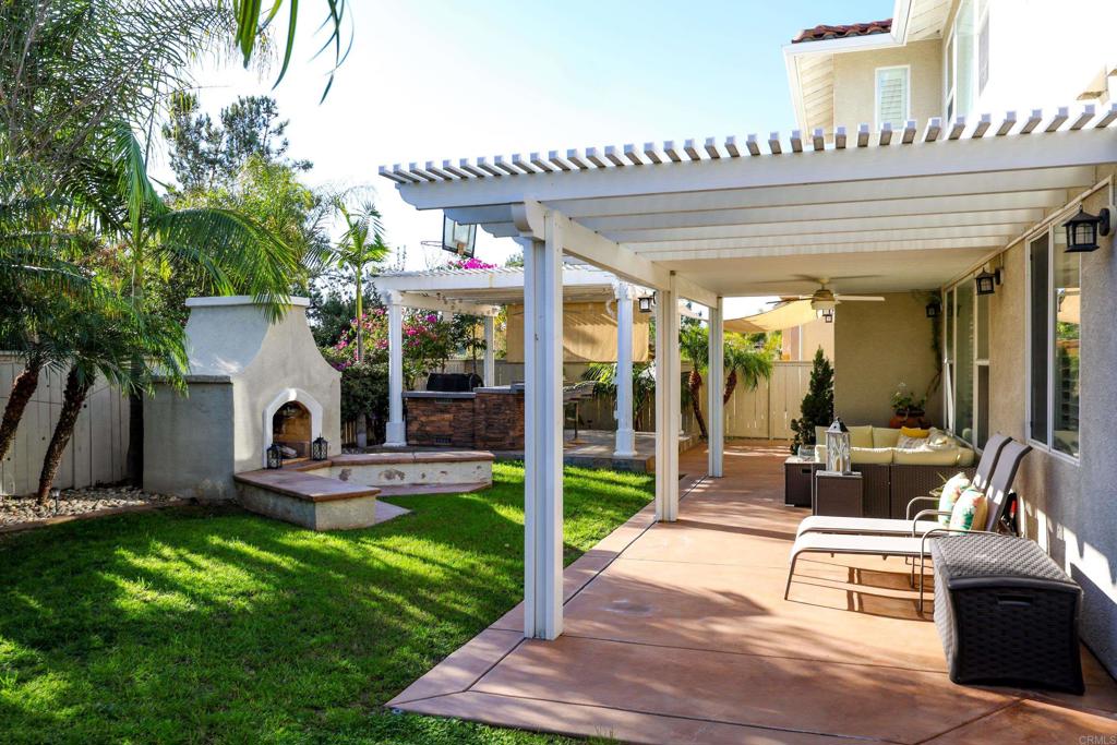 1446 Old Janal Ranch Road Chula Vista, CA 91915 - Photo 45 of 51 a view of a patio with table and chairs potted plants and floor to ceiling window