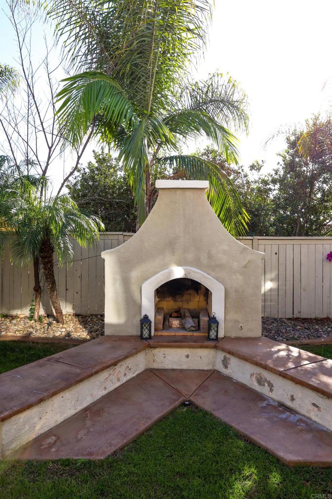 1446 Old Janal Ranch Road Chula Vista, CA 91915 - Photo 47 of 51 a view of backyard with a table and chairs under an umbrella