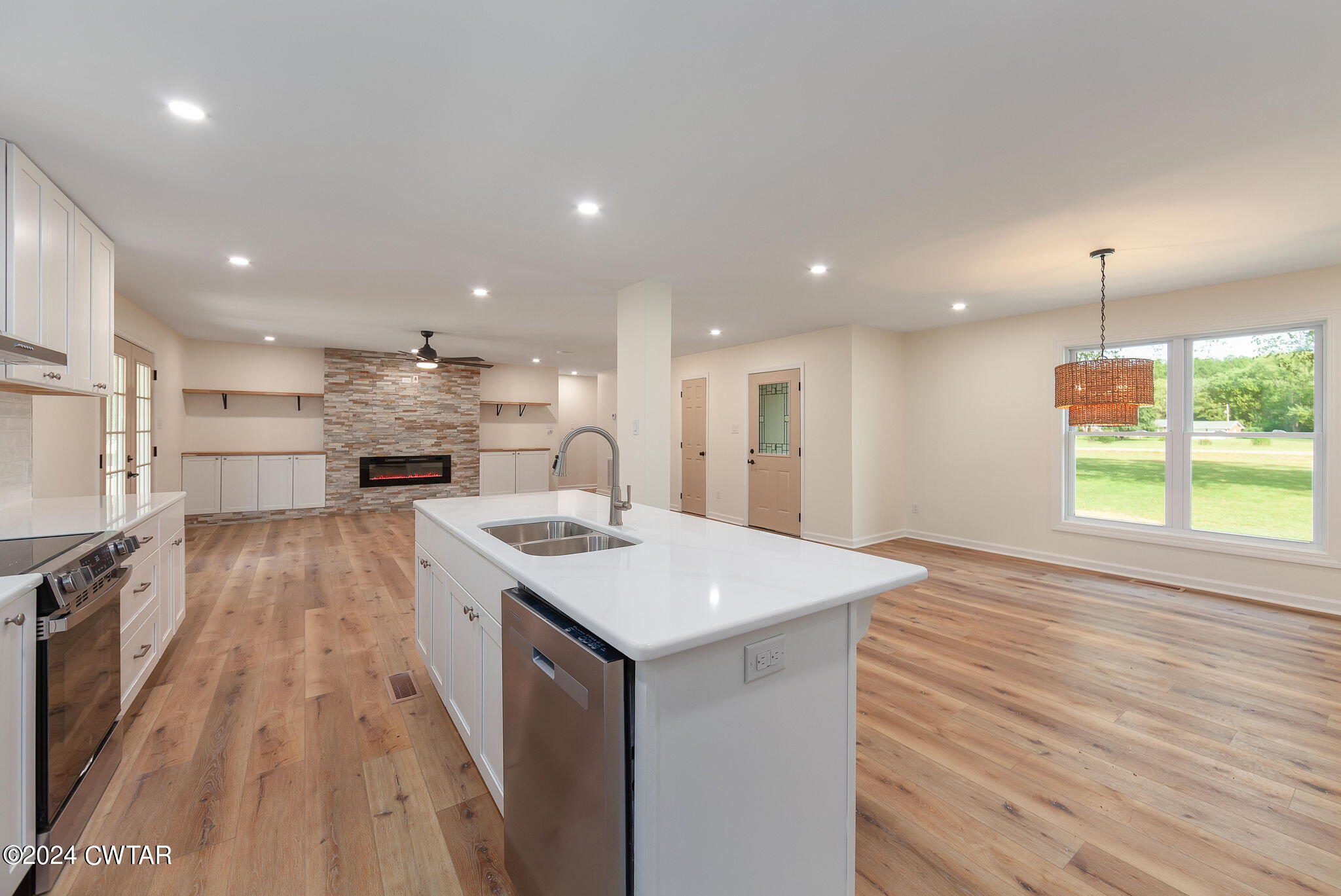 444 Diamond Grove Road Beech Bluff, TN 38313 - Photo 13 of 36 a open kitchen with kitchen island a sink stove and wooden floor