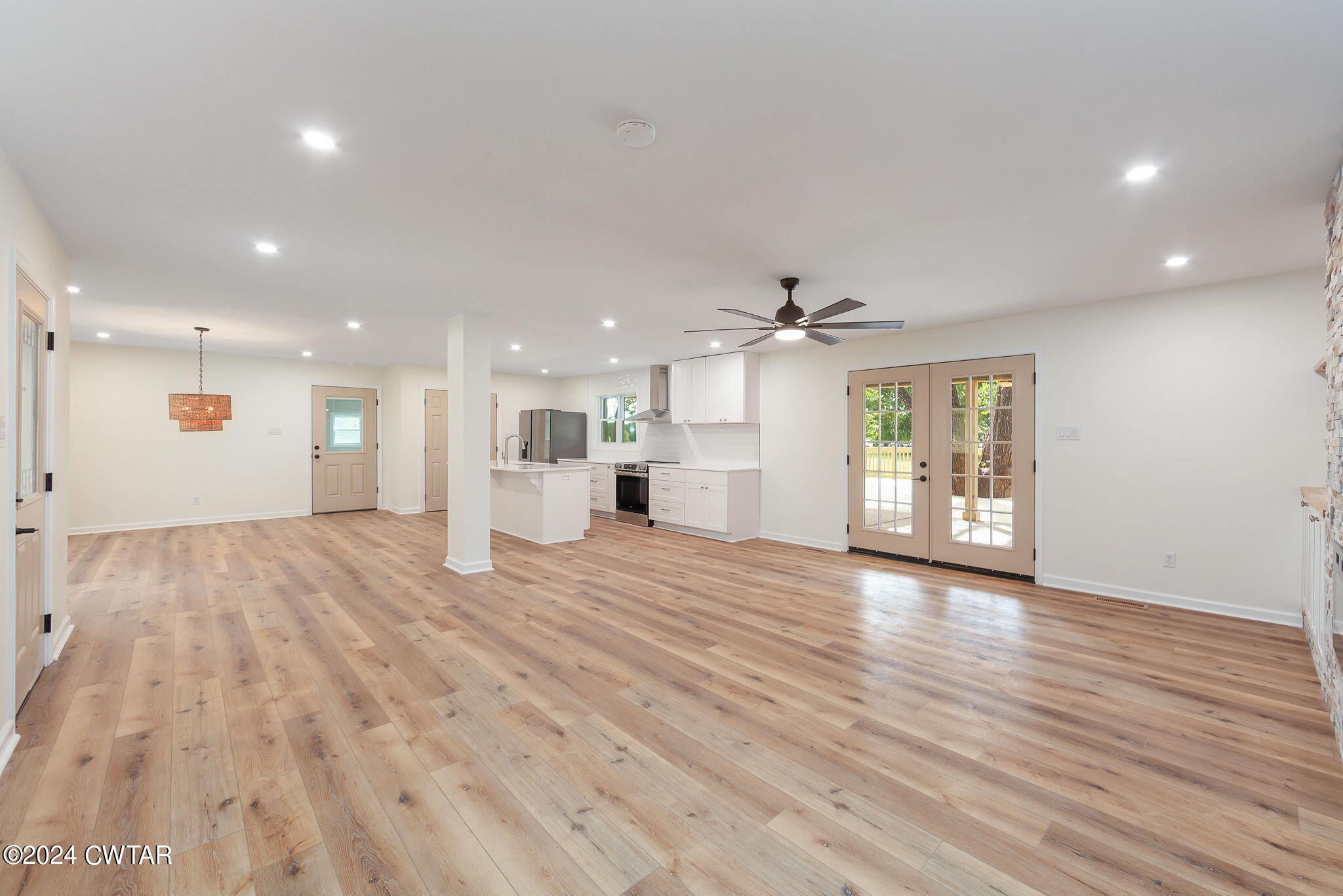 444 Diamond Grove Road Beech Bluff, TN 38313 - Photo 24 of 36 a view of an empty room with wooden floor and a kitchen