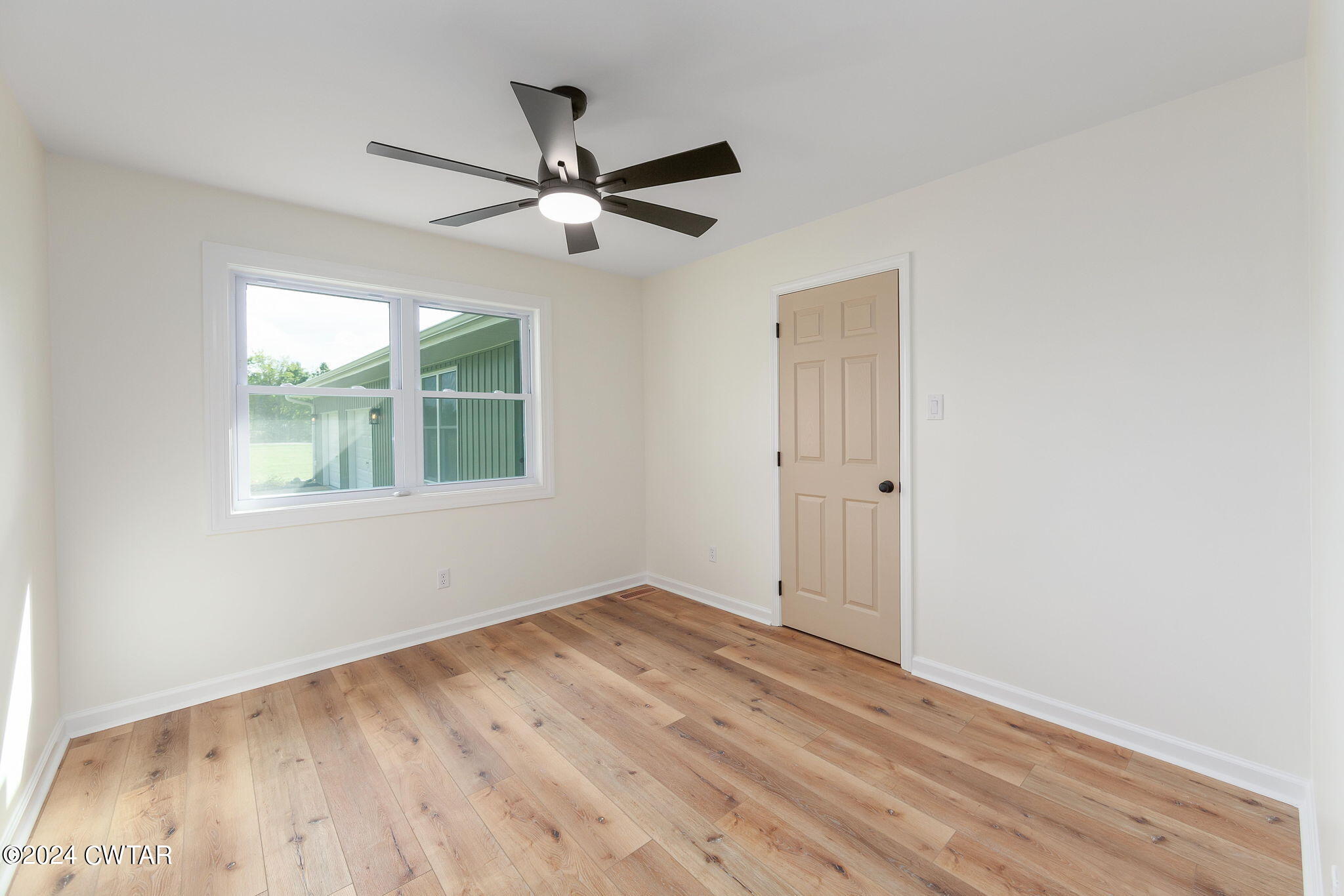 444 Diamond Grove Road Beech Bluff, TN 38313 - Photo 25 of 36 a view of empty room with wooden floor and fan