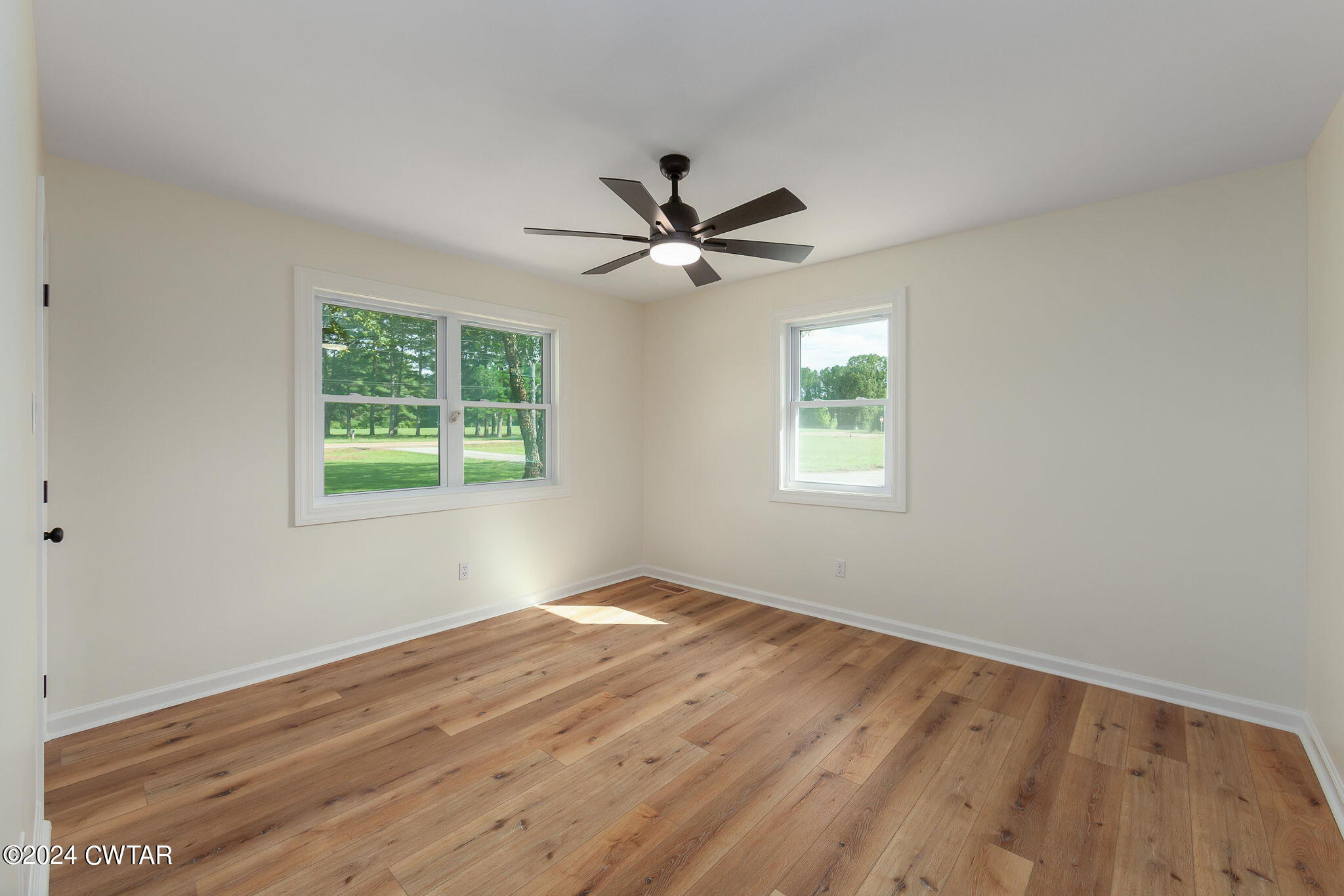 444 Diamond Grove Road Beech Bluff, TN 38313 - Photo 27 of 36 wooden floor in an empty room with a window