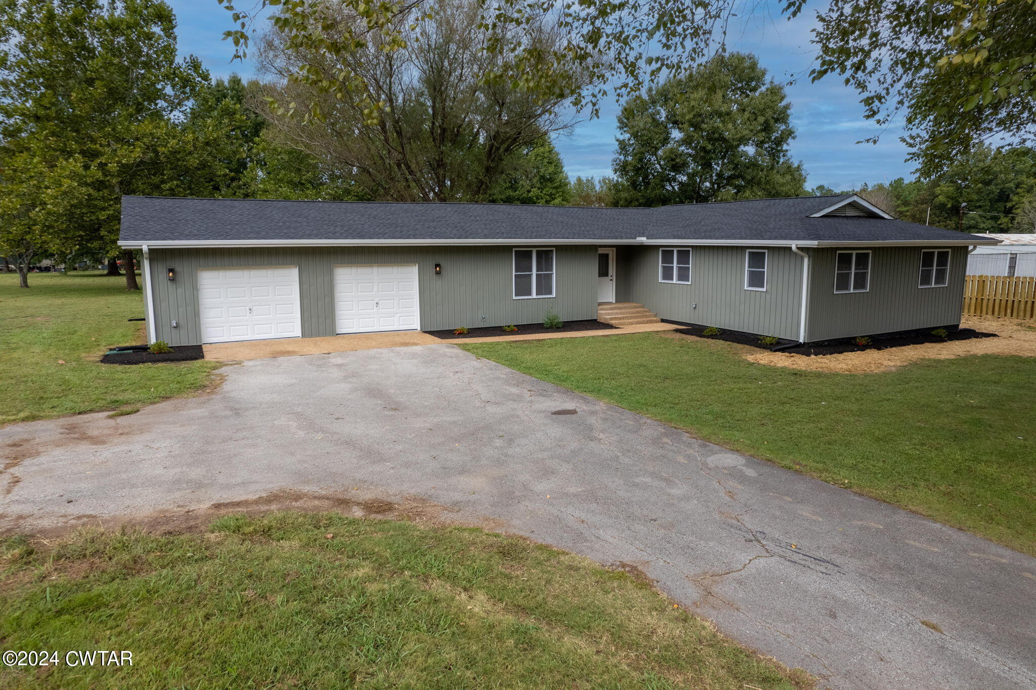444 Diamond Grove Road Beech Bluff, TN 38313 - Photo 36 of 36 a front view of a house with a yard and garage