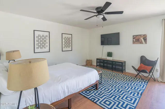 a bedroom with furniture and a rug