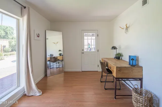 a view of a livingroom with furniture and a window