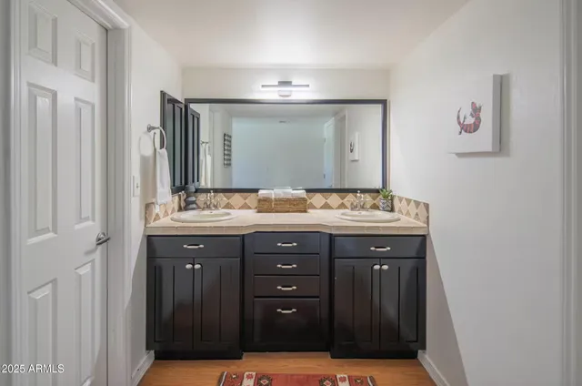 a bathroom with a sink and a mirror