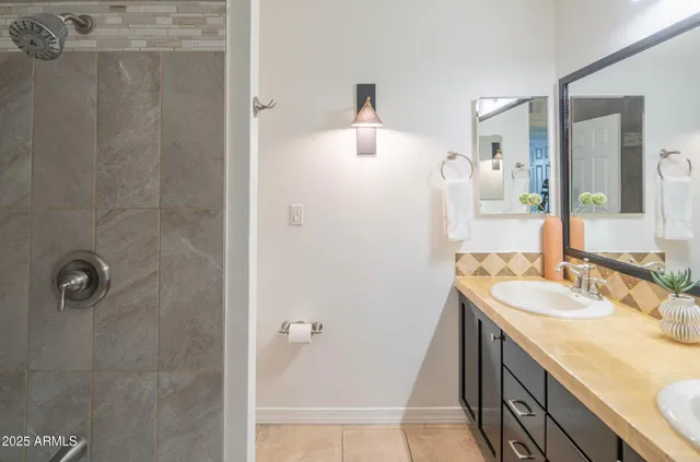 a bathroom with a sink a mirror and shower