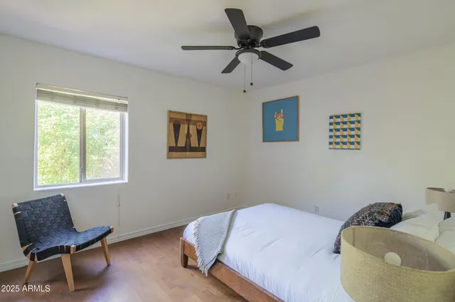 a bedroom with a bed and a chair